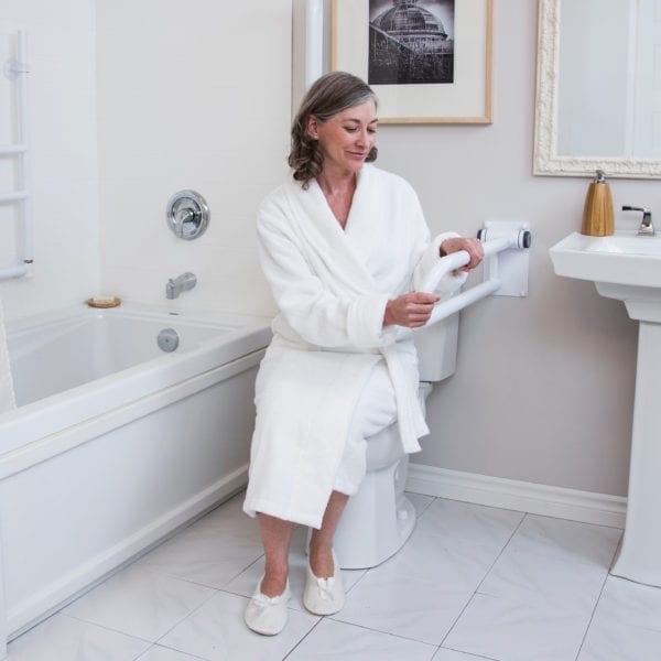 Woman holding the PT Rail in a bathroom, holding the rail for support