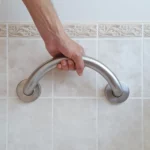 hand holding the crescent grab bar