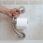 hand holding the tp grab bar