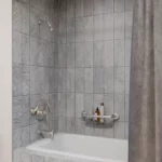shower with a brushed shampoo shelf
