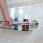 hand holding onto the shampoo shelf